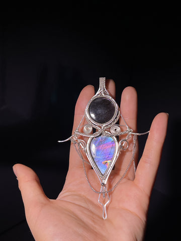 Handmade wire wrapped pendant with natural labradorite stone. Unique iridescent luster, vintage copper craft, delicate wearable ornament.